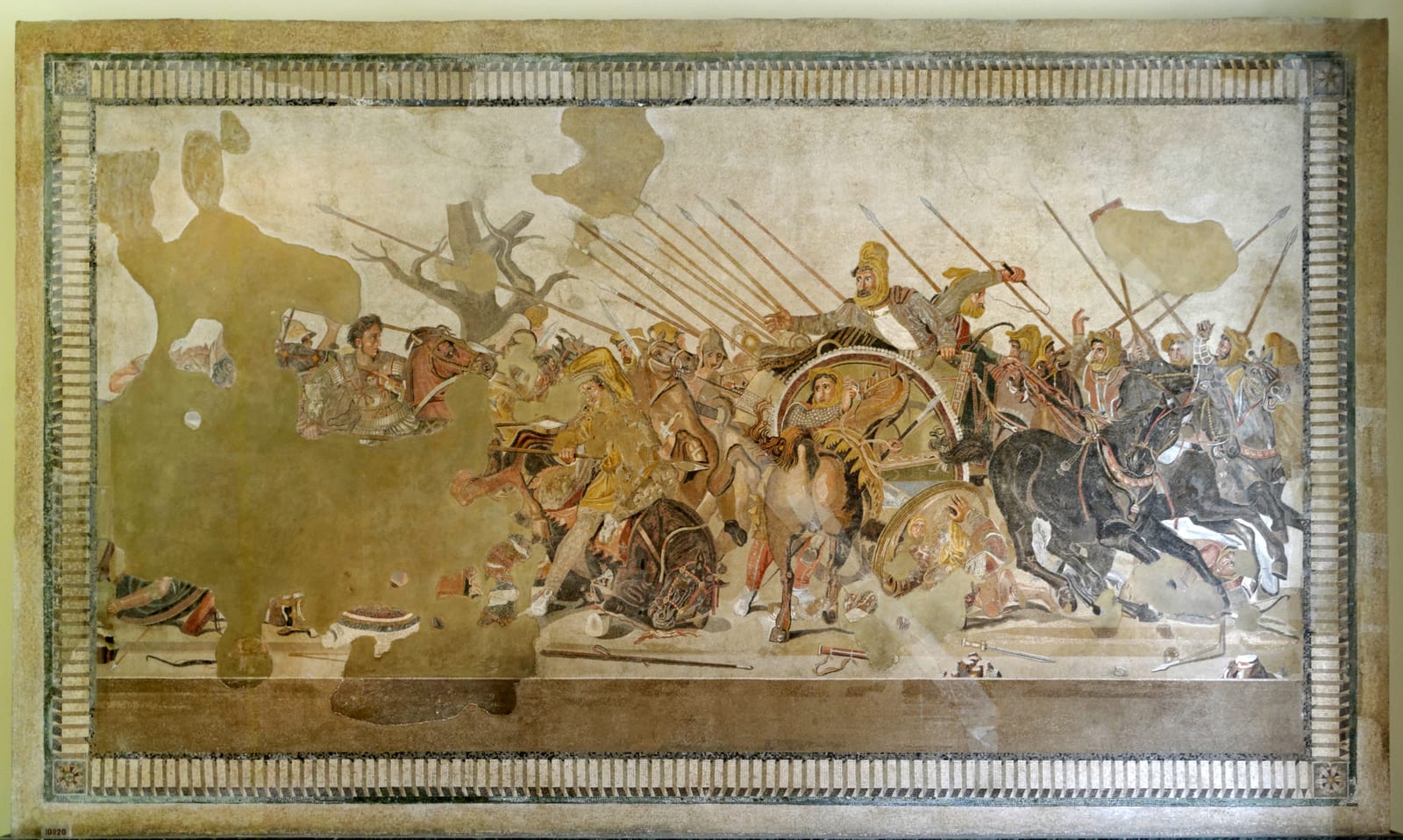 The Alexander Mosaic: a battle scene with Alexander on horseback at left charging toward Darius in his chariot at right, amid spears, horses and fallen soldiers; large areas of the left side are lost.