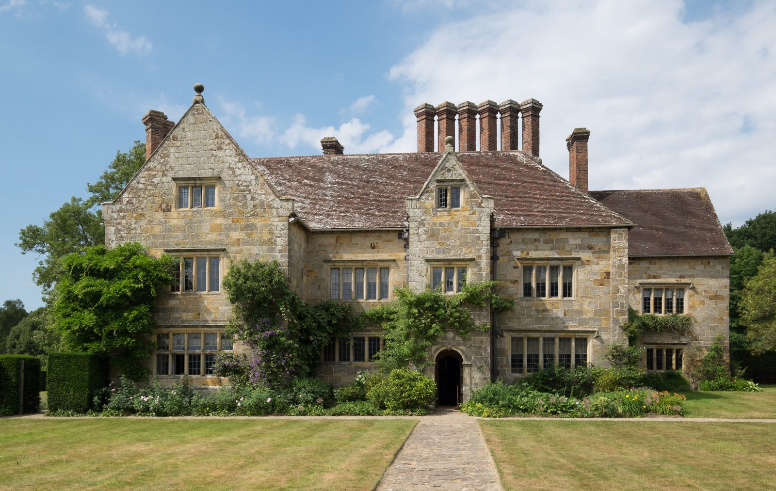 The front of Bateman’s, a seventeenth-century house in a green Sussex landscape.